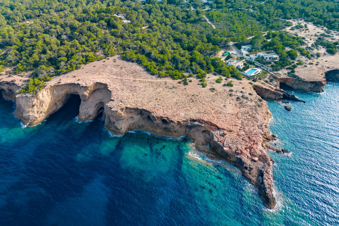 Ibiza Cala Bassa beach with turquoise water, aerial views